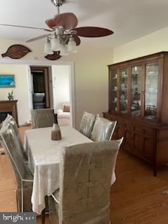 dining room with ceiling fan and dark hardwood / wood-style flooring