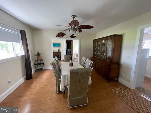 2826 Hoopers Island Rd, Church Creek, MD 21622 - dining area featuring a healthy amount of sunlight, baseboards, wood finished floors, and ceiling fan