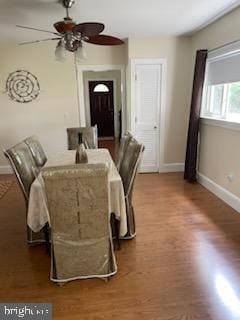 dining space with hardwood / wood-style flooring and ceiling fan