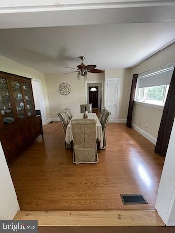 dining area featuring hardwood / wood-style flooring and ceiling fan