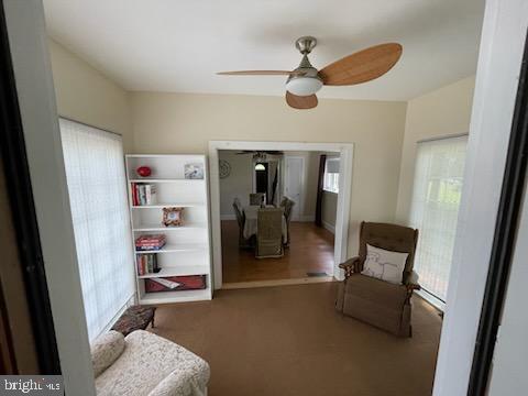 living area featuring ceiling fan