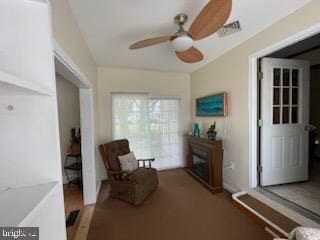 2826 Hoopers Island Rd, Church Creek, MD 21622 - sitting room featuring visible vents, ceiling fan, and a fireplace
