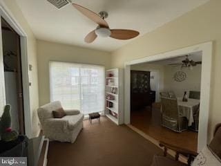 sitting room featuring ceiling fan