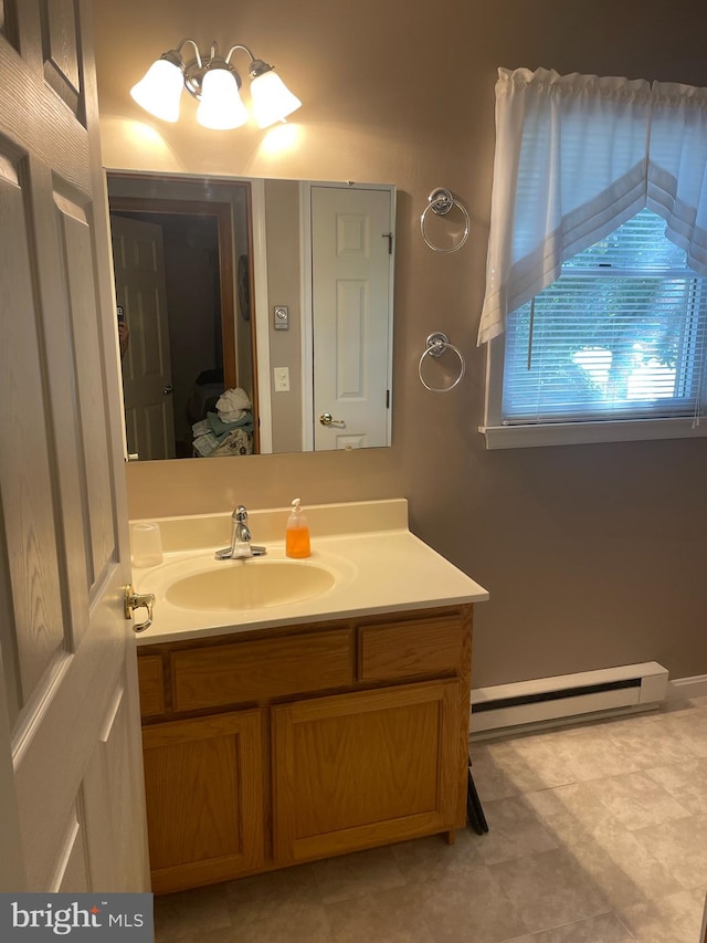 bathroom featuring vanity and baseboard heating