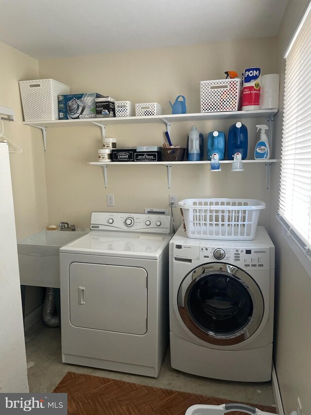 washroom featuring independent washer and dryer, sink, and plenty of natural light