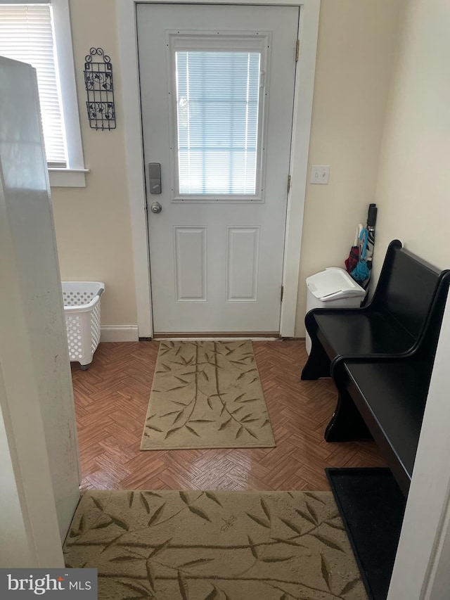 doorway to outside with light parquet flooring