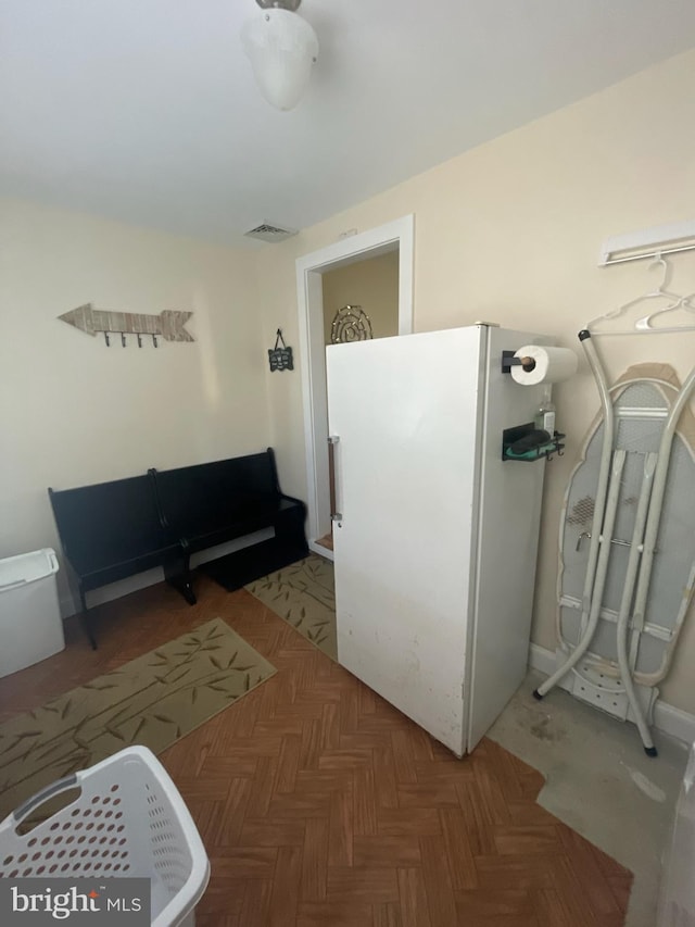 interior space featuring parquet floors and white fridge