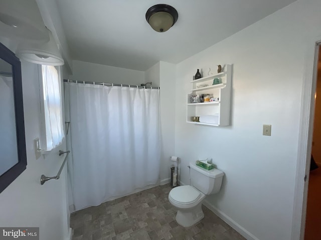 2826 Hoopers Island Rd, Church Creek, MD 21622 - bathroom featuring stone finish flooring, toilet, a shower with curtain, and baseboards