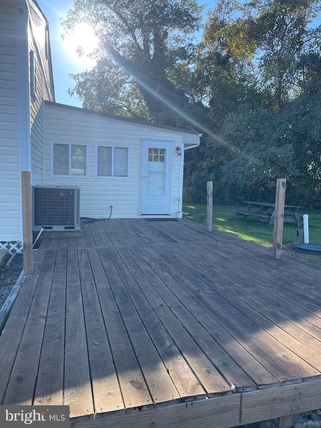 wooden terrace featuring cooling unit