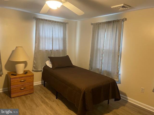 bedroom with ceiling fan and wood-type flooring