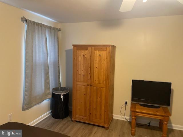 bedroom with wood-type flooring and ceiling fan