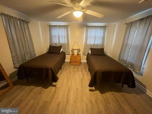 bedroom with light wood-type flooring and ceiling fan