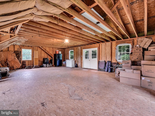 unfinished attic with water heater and washer / clothes dryer