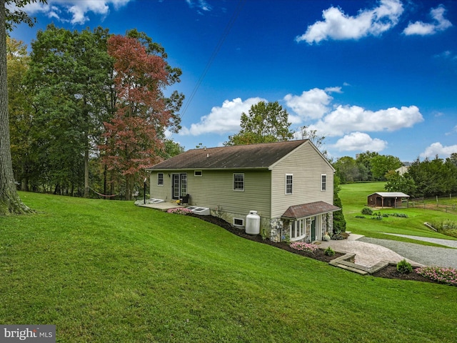 view of side of home with a yard