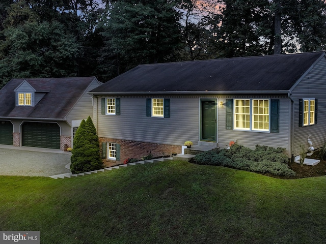 view of front of property with a garage and a front lawn