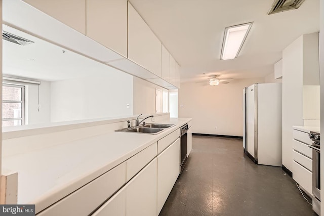 kitchen featuring ceiling fan, white cabinets, white refrigerator, and sink