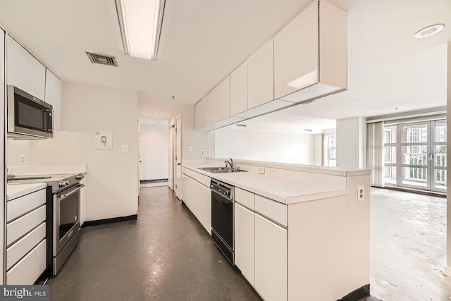 kitchen with appliances with stainless steel finishes, sink, and white cabinets