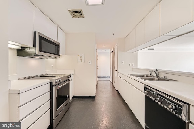 kitchen with appliances with stainless steel finishes, sink, and white cabinetry