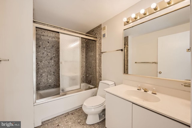 full bathroom featuring toilet, vanity, and enclosed tub / shower combo