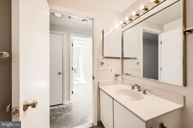 bathroom with concrete flooring and vanity