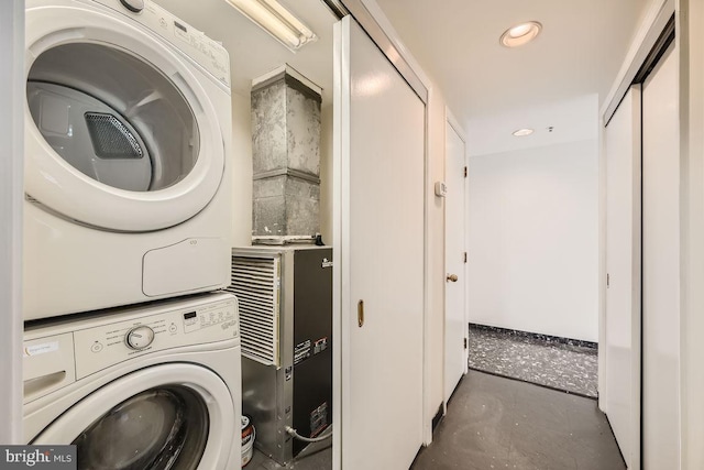 clothes washing area featuring stacked washer and dryer