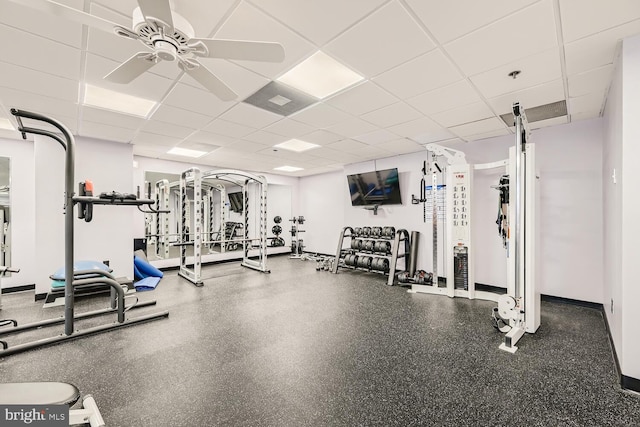 gym featuring a paneled ceiling and ceiling fan