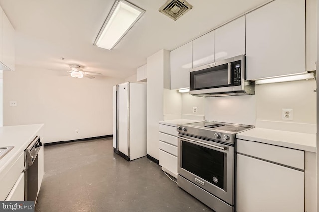 kitchen featuring ceiling fan, appliances with stainless steel finishes, concrete flooring, and white cabinetry