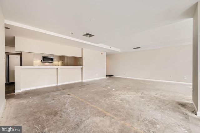 unfurnished living room with concrete floors