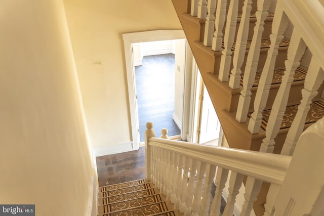 staircase with hardwood / wood-style floors and plenty of natural light