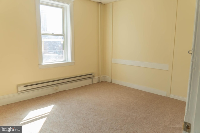 empty room featuring a baseboard radiator and light carpet