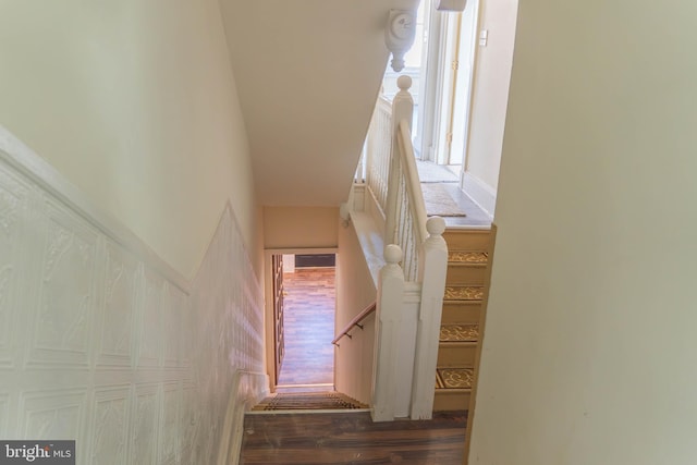 staircase with hardwood / wood-style floors