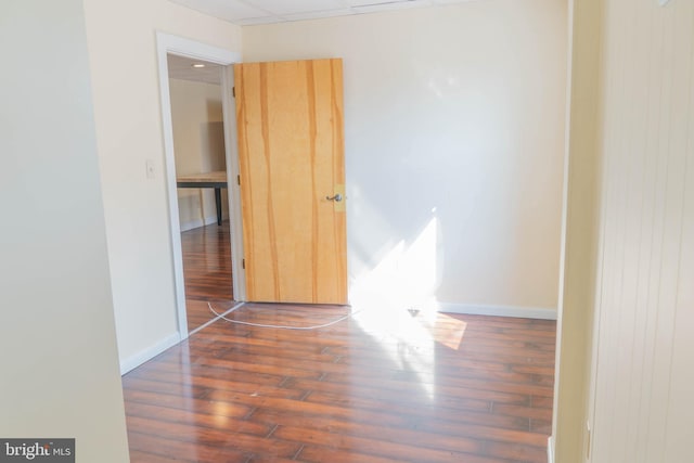 unfurnished room with dark hardwood / wood-style flooring