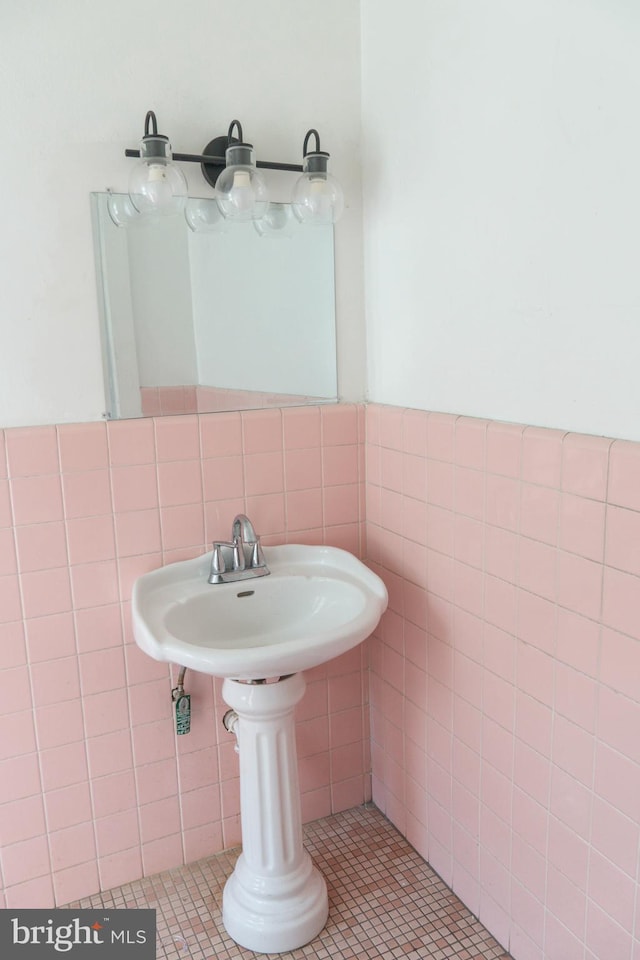 bathroom with tile walls and tile patterned flooring