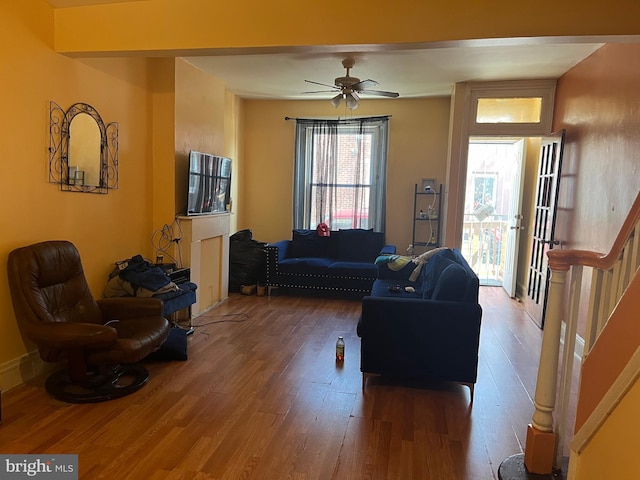 living room featuring ceiling fan and hardwood / wood-style flooring