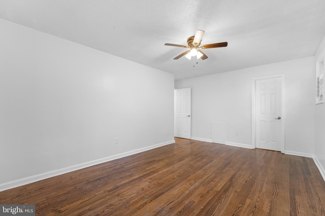 spare room featuring ceiling fan and dark hardwood / wood-style flooring