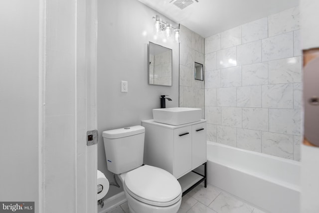 full bathroom with vanity, tiled shower / bath combo, and toilet