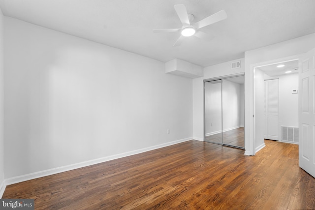 unfurnished bedroom with hardwood / wood-style floors, a closet, and ceiling fan