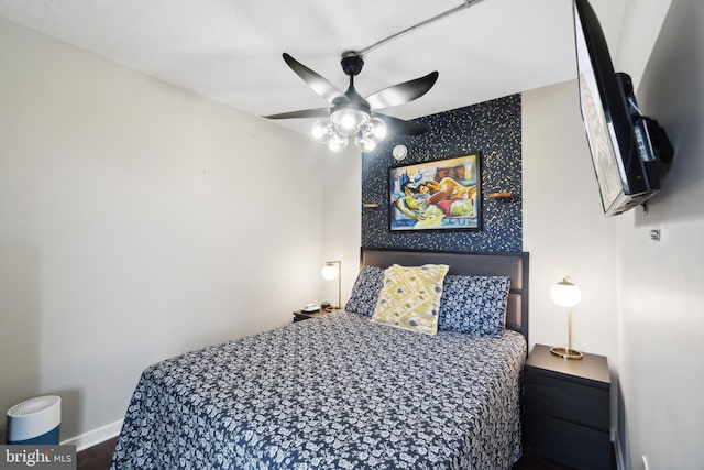 bedroom featuring hardwood / wood-style flooring and ceiling fan