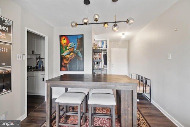 dining space with sink and dark hardwood / wood-style floors