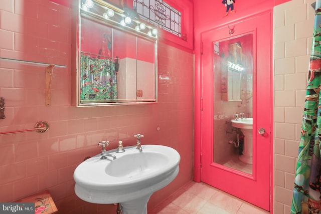 bathroom featuring sink, tile patterned flooring, and tile walls