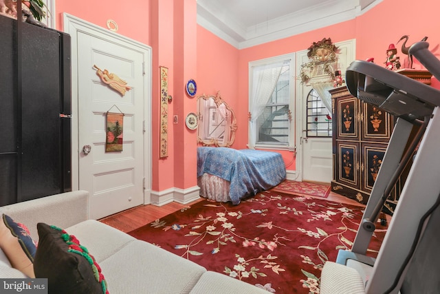 sitting room with ornamental molding and hardwood / wood-style flooring