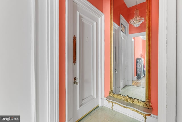 corridor featuring a chandelier and light tile patterned floors