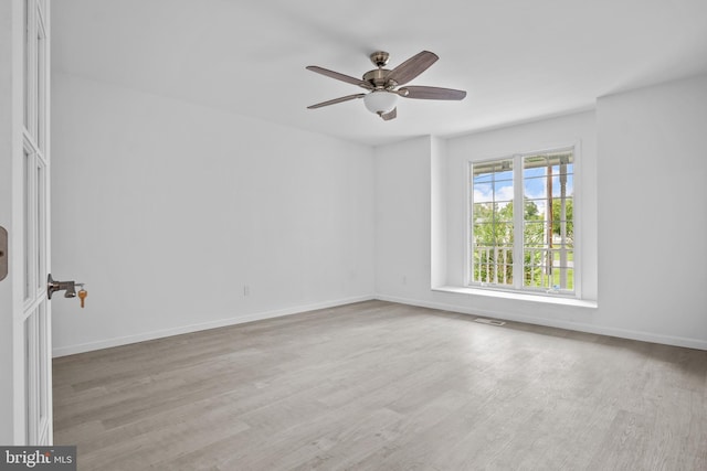 spare room featuring light hardwood / wood-style flooring and ceiling fan