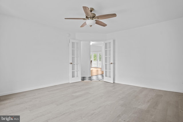 unfurnished room with french doors, light wood-type flooring, and ceiling fan