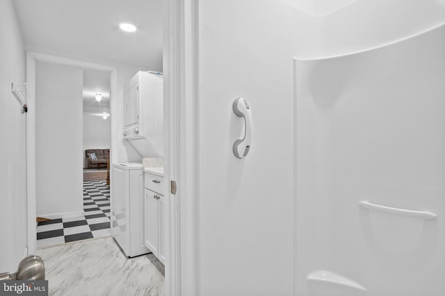 bathroom featuring vanity and stacked washer and clothes dryer