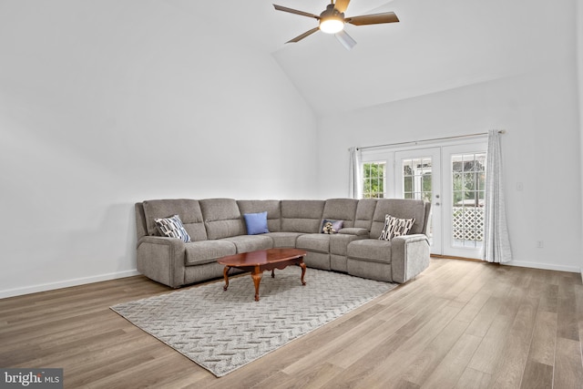 living room featuring hardwood / wood-style floors, french doors, high vaulted ceiling, and ceiling fan