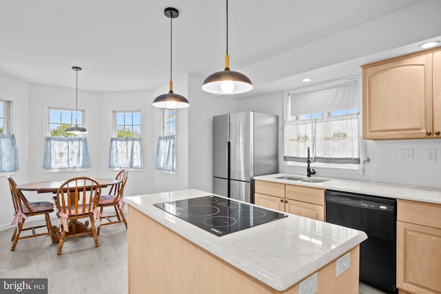 kitchen with sink, black appliances, decorative light fixtures, light brown cabinetry, and light hardwood / wood-style floors