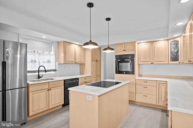 kitchen with a kitchen island, light brown cabinets, light hardwood / wood-style flooring, sink, and black appliances