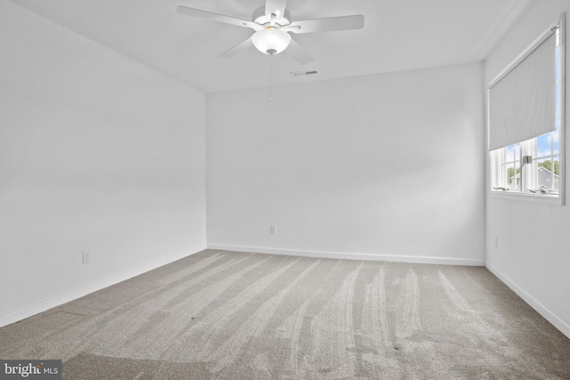 carpeted spare room with ceiling fan