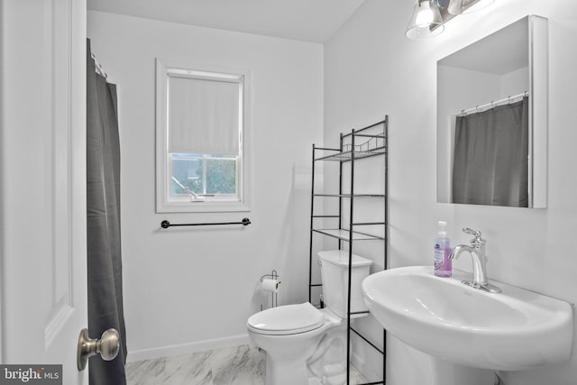 bathroom featuring sink and toilet